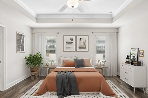 Primary bedroom with king size bed and large window.