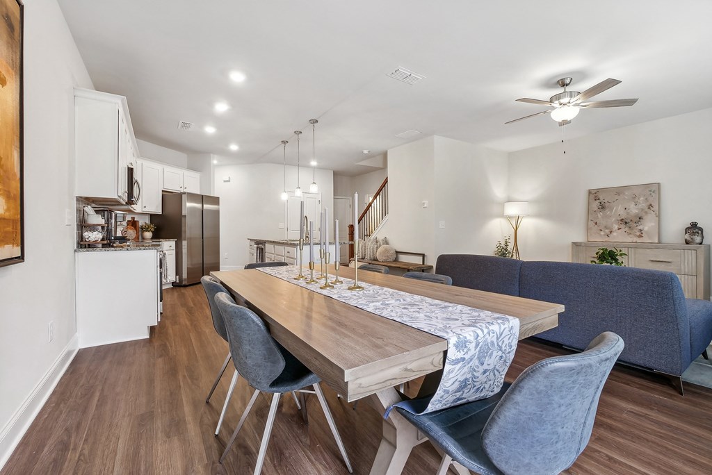 a dining room with a wooden table and blue chairs