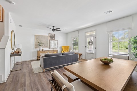 Living room with large couch, accent chairs, and windows.