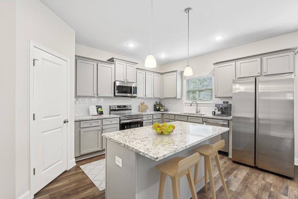 Another view of the spacious kitchen and stainless steel appliances