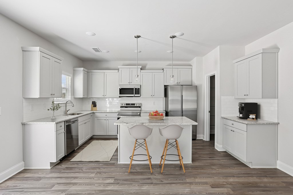 Spacious kitchen with an island, ample storage, and stainless steel appliances.