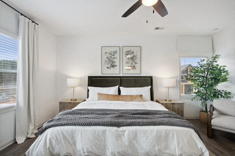 a bedroom with a bed and a ceiling fan