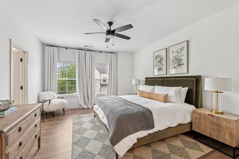 Primary Bedroom with king size bed and large window letting in nice natural light.