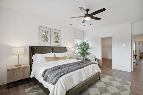 “Serene primary suite with a plush king bed, refined finishes, and calming greenery—your private retreat for rest and relaxation.”