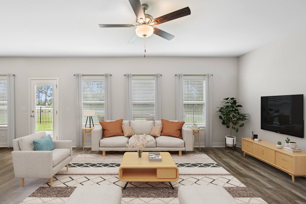 Sophisticated living space with a crisp white sofa, natural wood accents, and modern ceiling fan—where comfort meets timeless design.