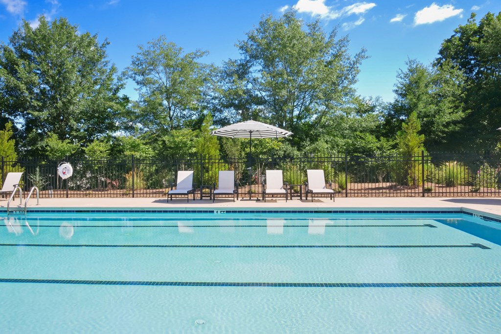 Covered poolside lounge with elegant seating.