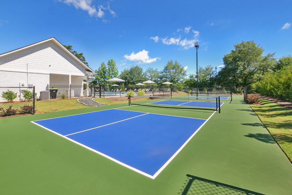 Tennis court conveniently located beside the clubhouse for easy access.