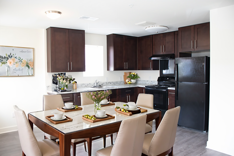 A kitchen with a table set for a meal.