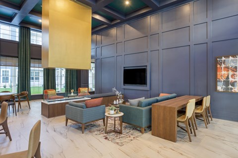 a living room with blue walls and a table and chairs