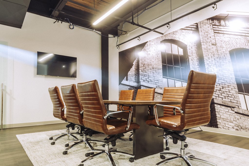 a conference room with a table and chairs and a tv at The Mill at Prattville, Prattville, Alabama