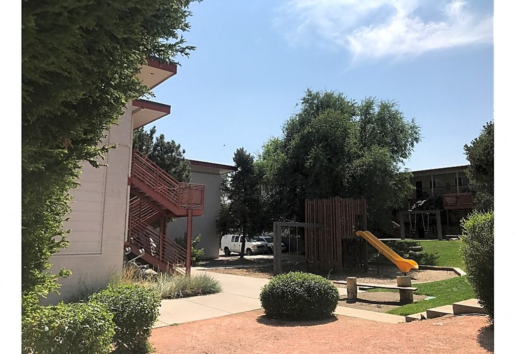 a backyard with a playground and a swing