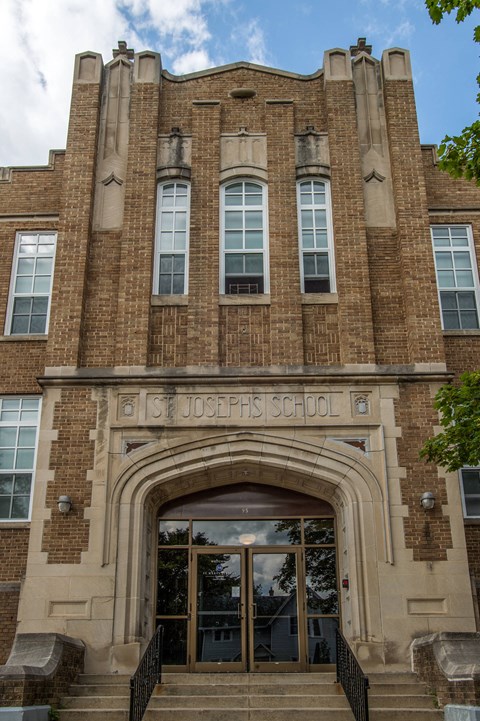 The front of St. Joseph's School building with a clear blue sky in the background.