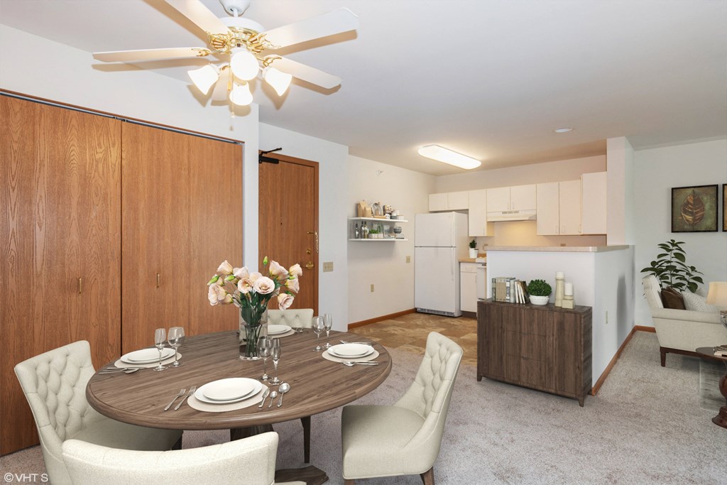A dining room with a round table set for four.