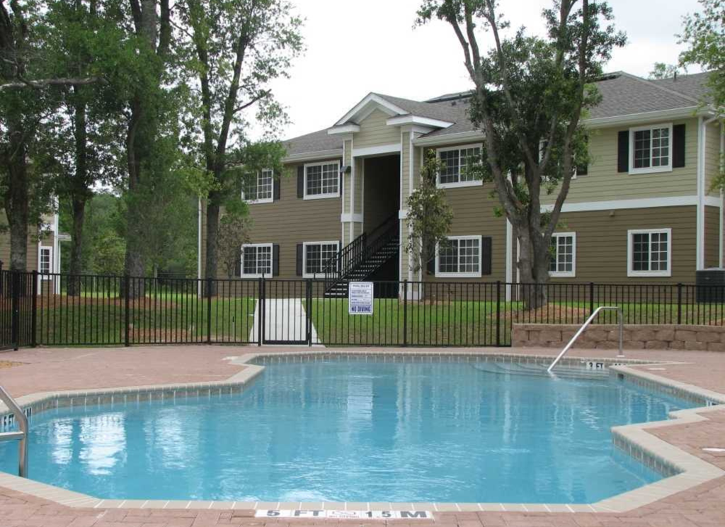 a swimming pool in front of an apartment building