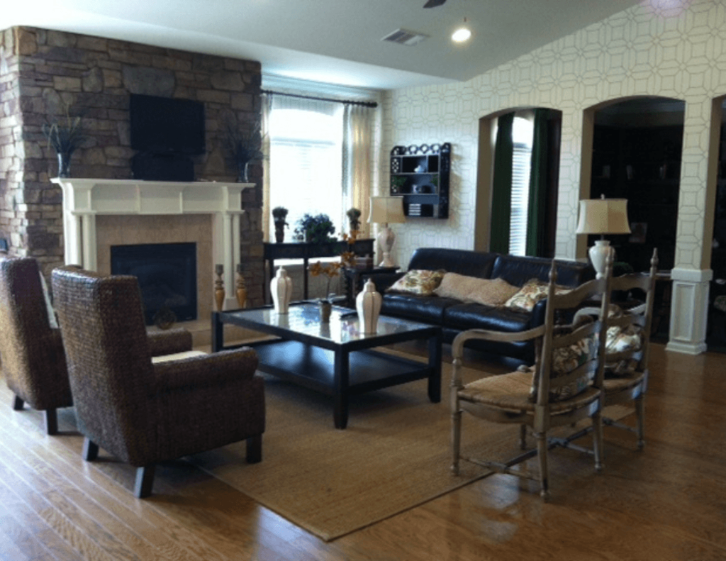 the living room has a stone fireplace and leather couches