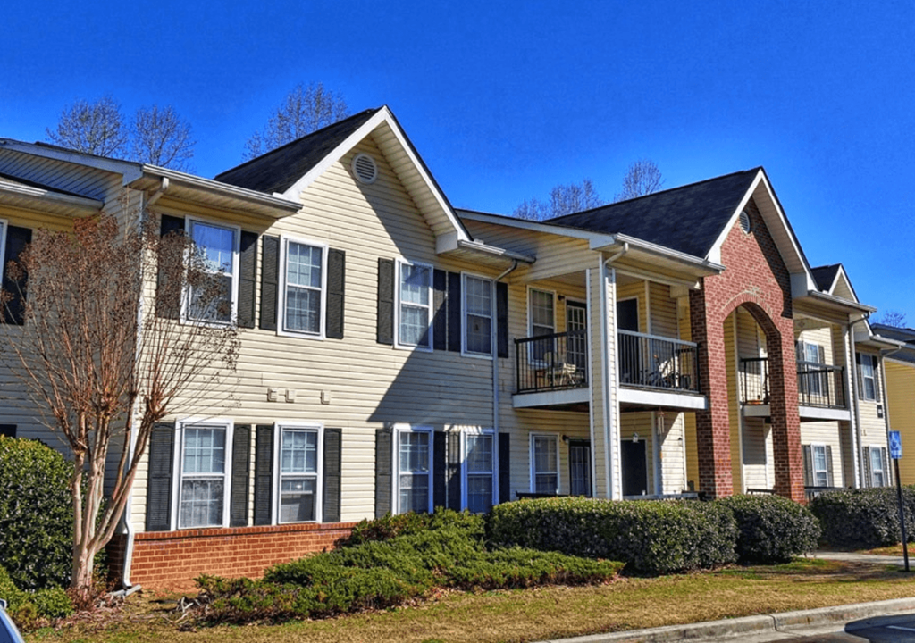 the view of an apartment building with two stories and a balcony