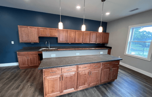 a kitchen with wooden cabinets and a counter top