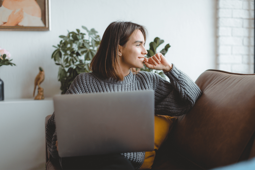 a red house with green grass and a sidewalk