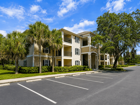 A large building with a parking lot in front of it.
