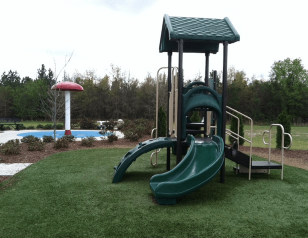 a playground with a swing set and a pool