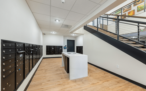 a large room with a staircase and a desk in the middle