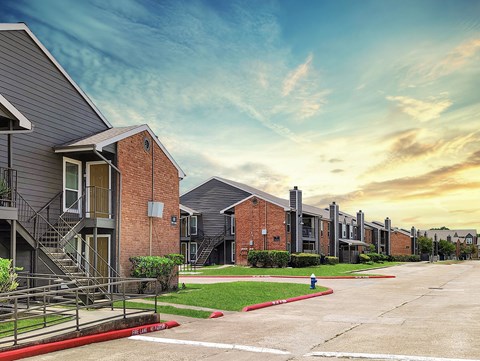 A row of modern houses with a red fire hydrant in the foreground.