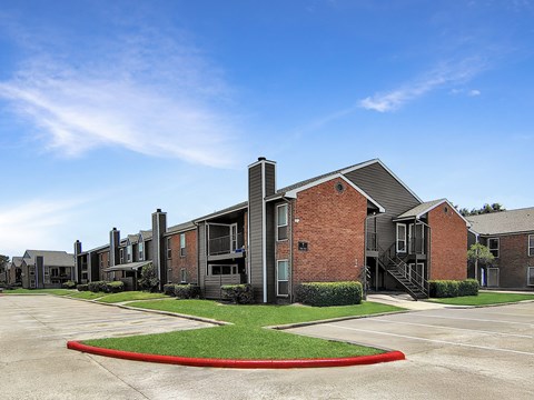 A large building with a red circle in the middle of the parking lot.