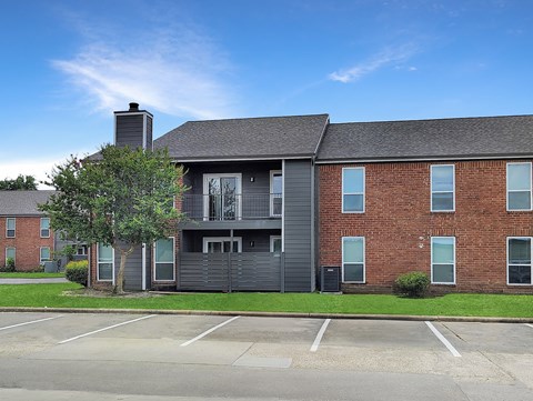 A large brick building with a black garage door in front.