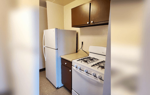 a kitchen with a stove and a refrigerator
