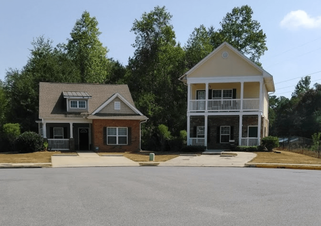 two houses on the side of a street