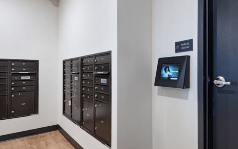 a view of a room with mailboxes and a television on the wall