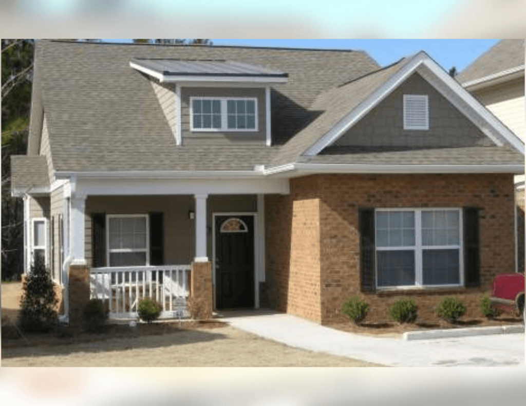 a house with a porch and a black door
