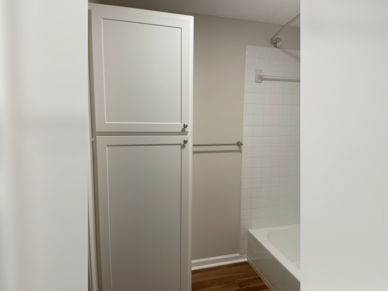a white refrigerator freezer sitting next to a bath tub