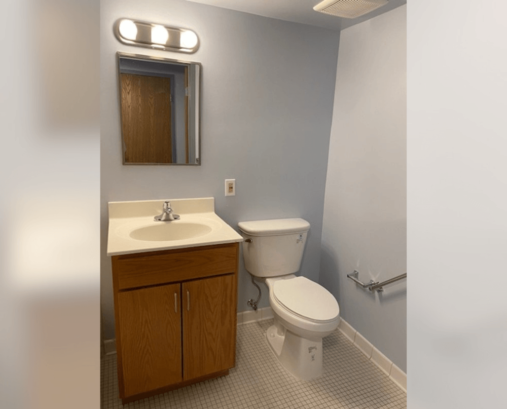 an empty bathroom with a toilet and a sink
