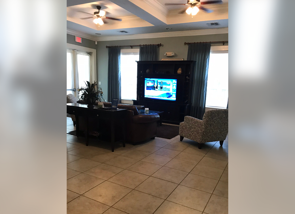 a living room with a tv and a table and chairs