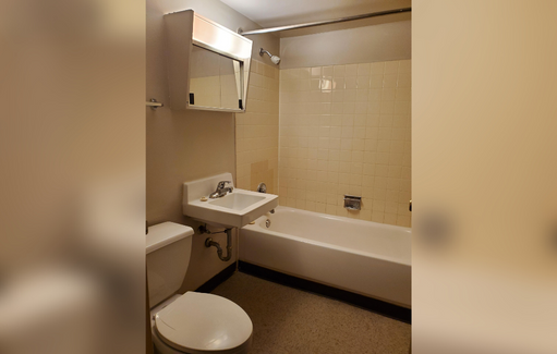 a small bathroom with a sink toilet and bath tub