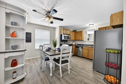 A kitchen with a table and chairs in the middle of the room.
