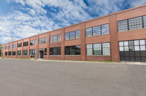 A long brick building with many windows and doors.