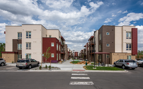 a row of new apartment buildings on a city street