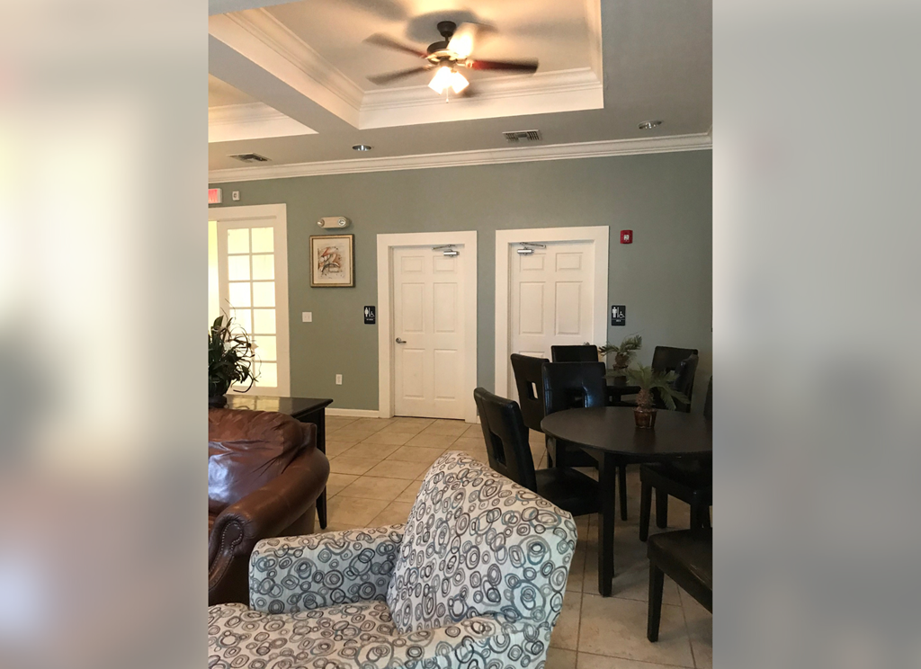 a living room and dining room with a ceiling fan