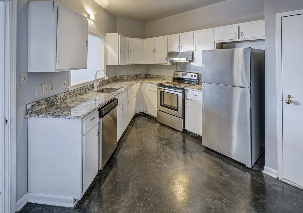 A kitchen with white cabinets and stainless steel appliances.