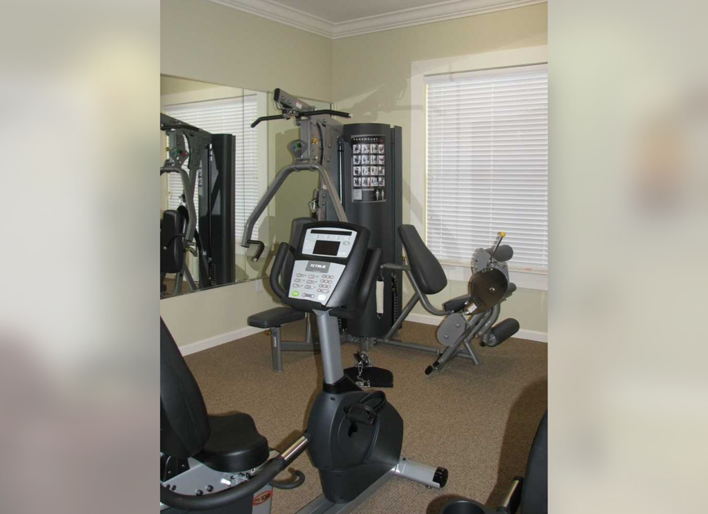 a home gym with a treadmill and exercise equipment