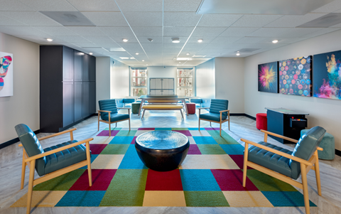 a large room with chairs and a table in the middle