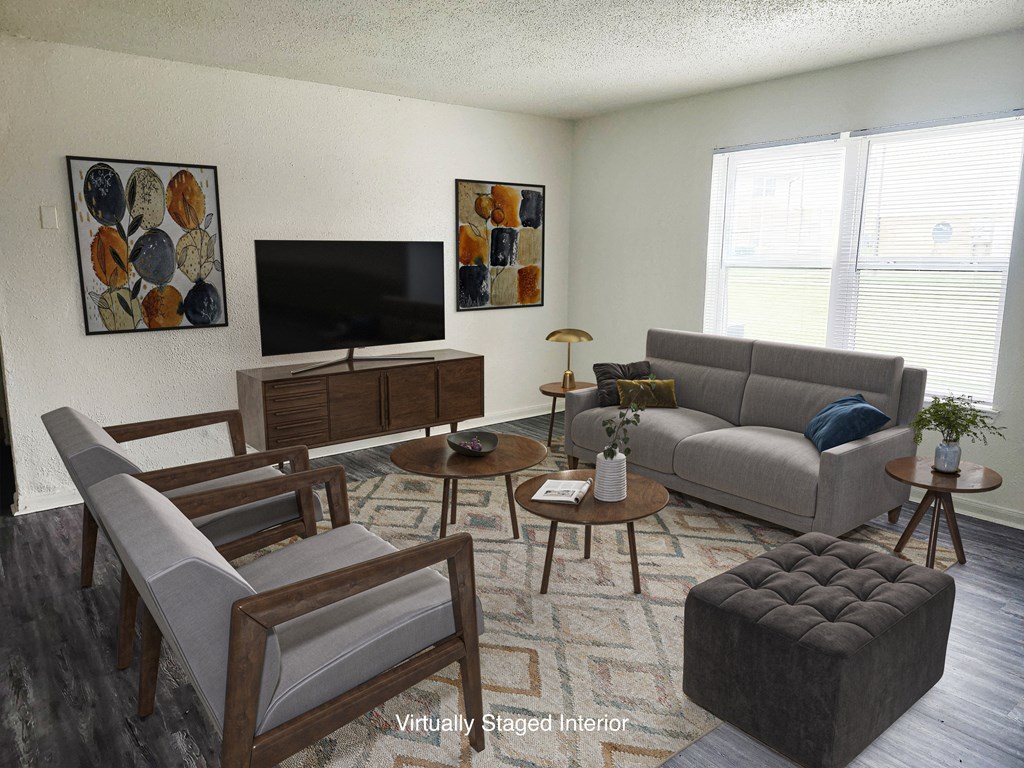 a living room with couches and chairs and a television