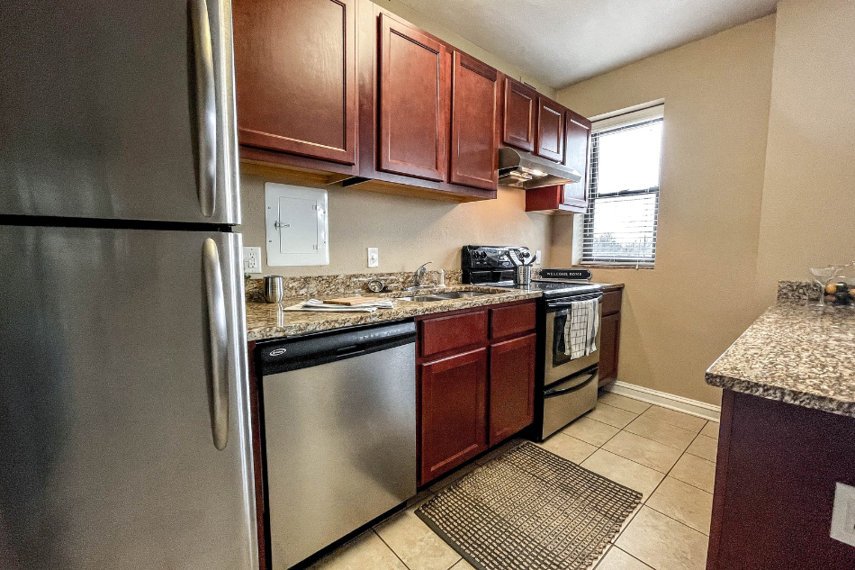 a kitchen with stainless steel appliances and wooden cabinets