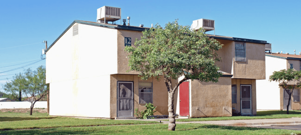A house with a tree in front of it.