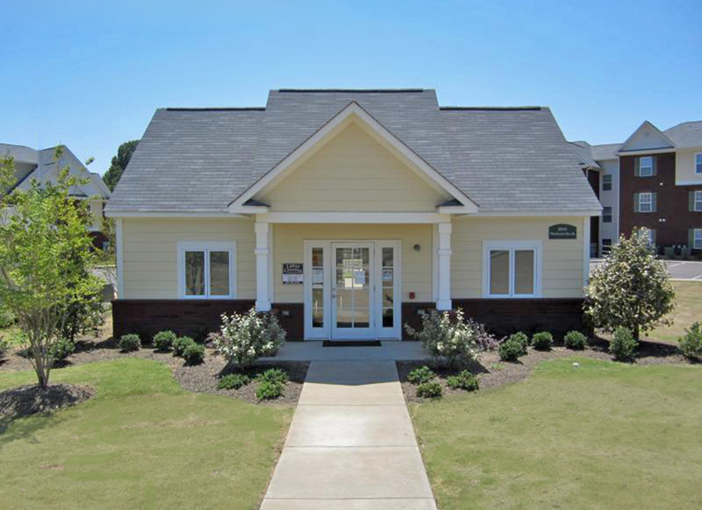a white house with a sidewalk in front of it