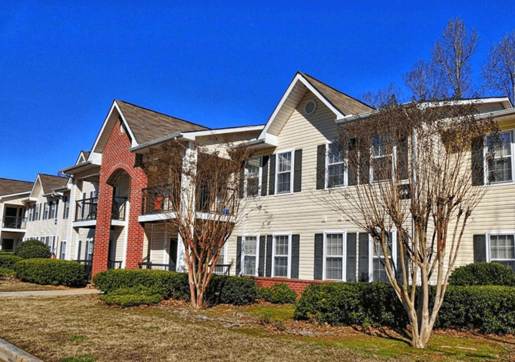 a row of houses with trees in front of them
