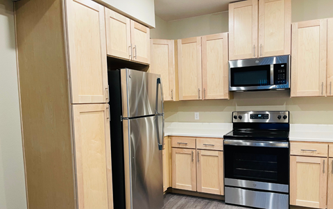 a kitchen with stainless steel appliances and wooden cabinets
