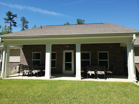 A house with a covered patio and a white door.